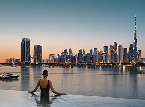 creek bay pool at sunset overlooking the dubai skyline